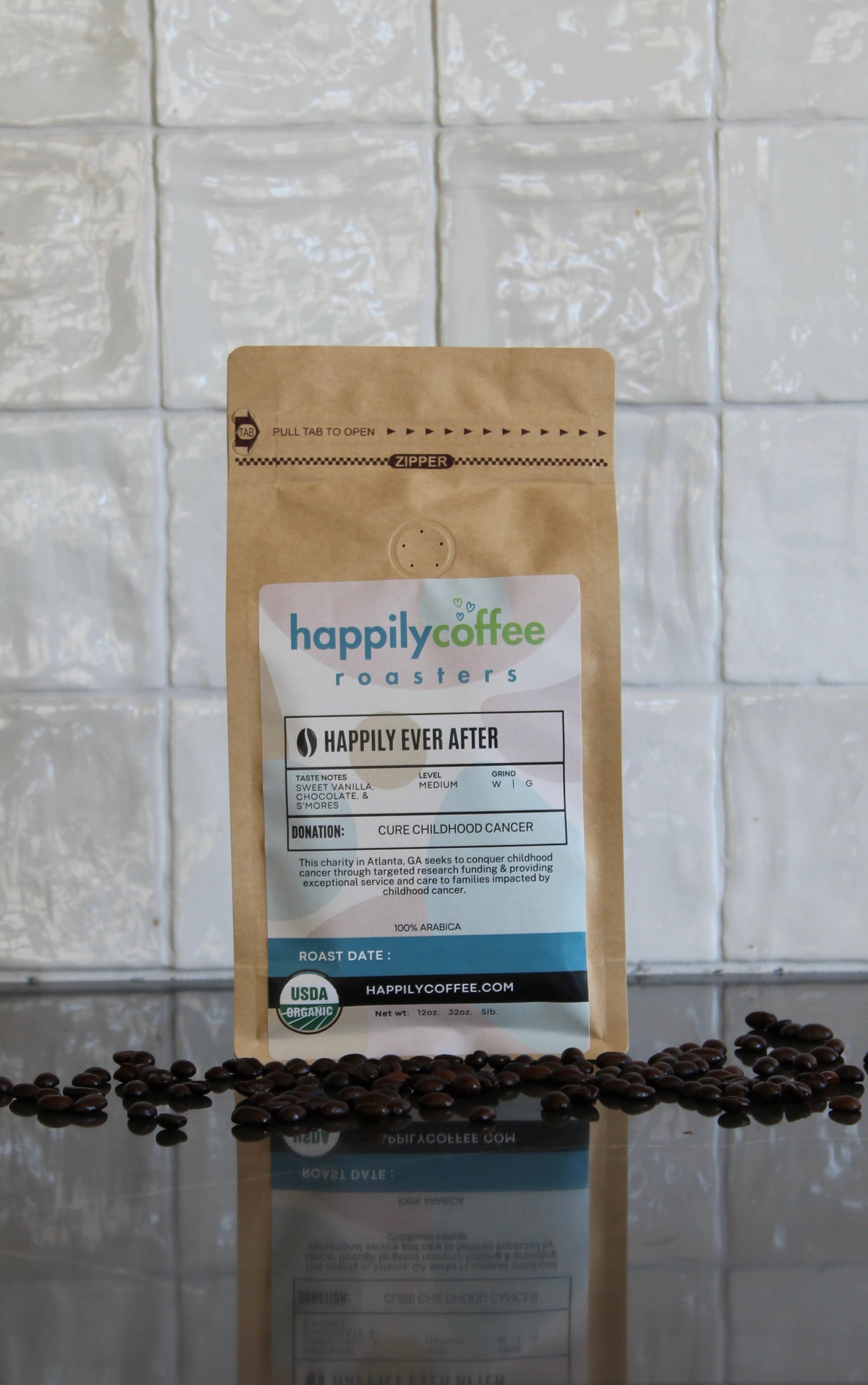 Happily Coffee Roasters 'Happily Ever After' coffee package with scattered beans on a reflective surface.