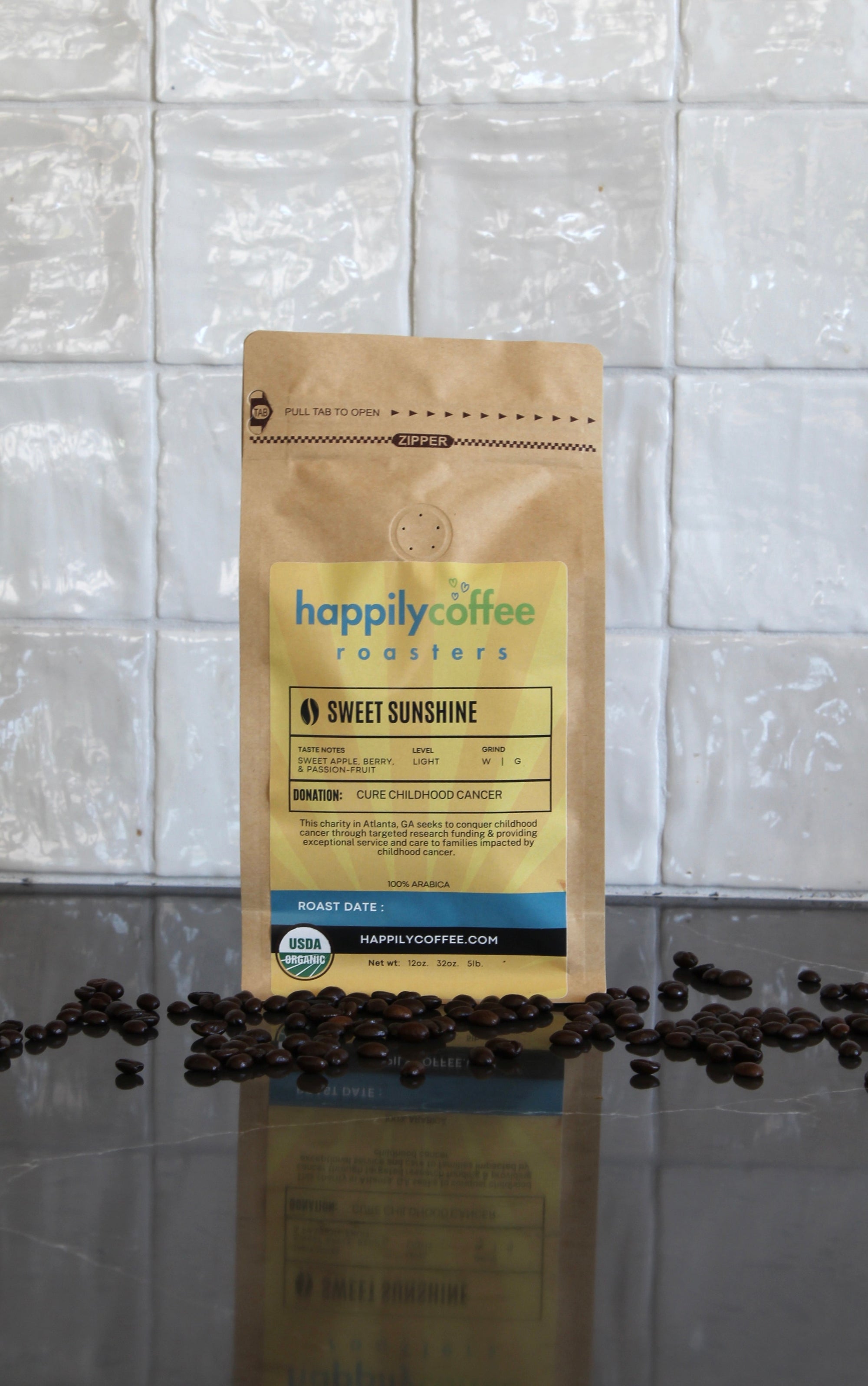 Happily Coffee Roasters package with coffee beans on a tiled surface