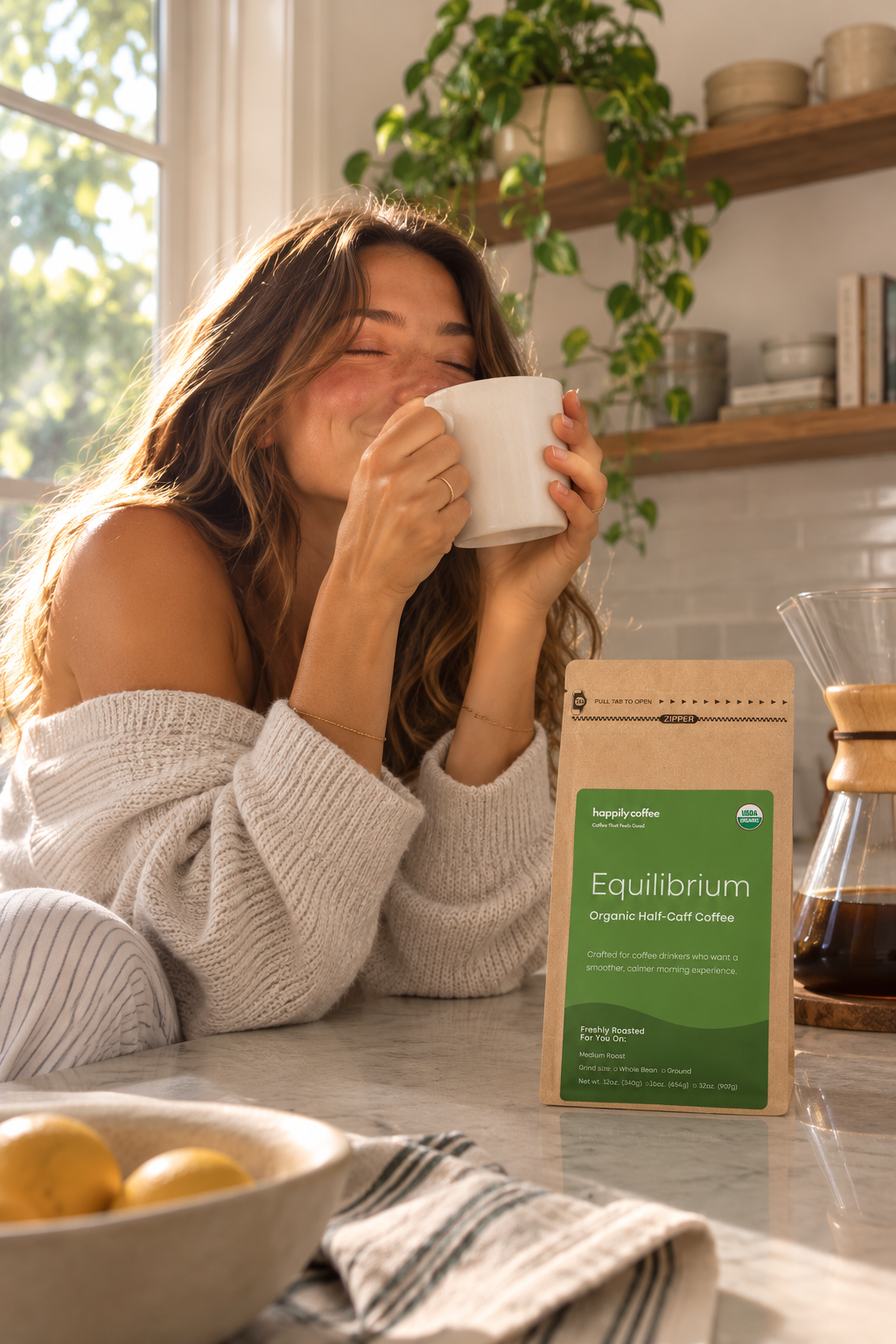 A woman enjoying happily coffee's usda organic half-caff coffee called equilibrium. freshly roasted in small batch and blended using swiss water process decaf coffee and usda organic specialty coffee medium roast coffee.