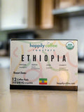 A box of Happily Coffee Roasters Ethiopia organic single-serve coffee pods on a kitchen countertop.